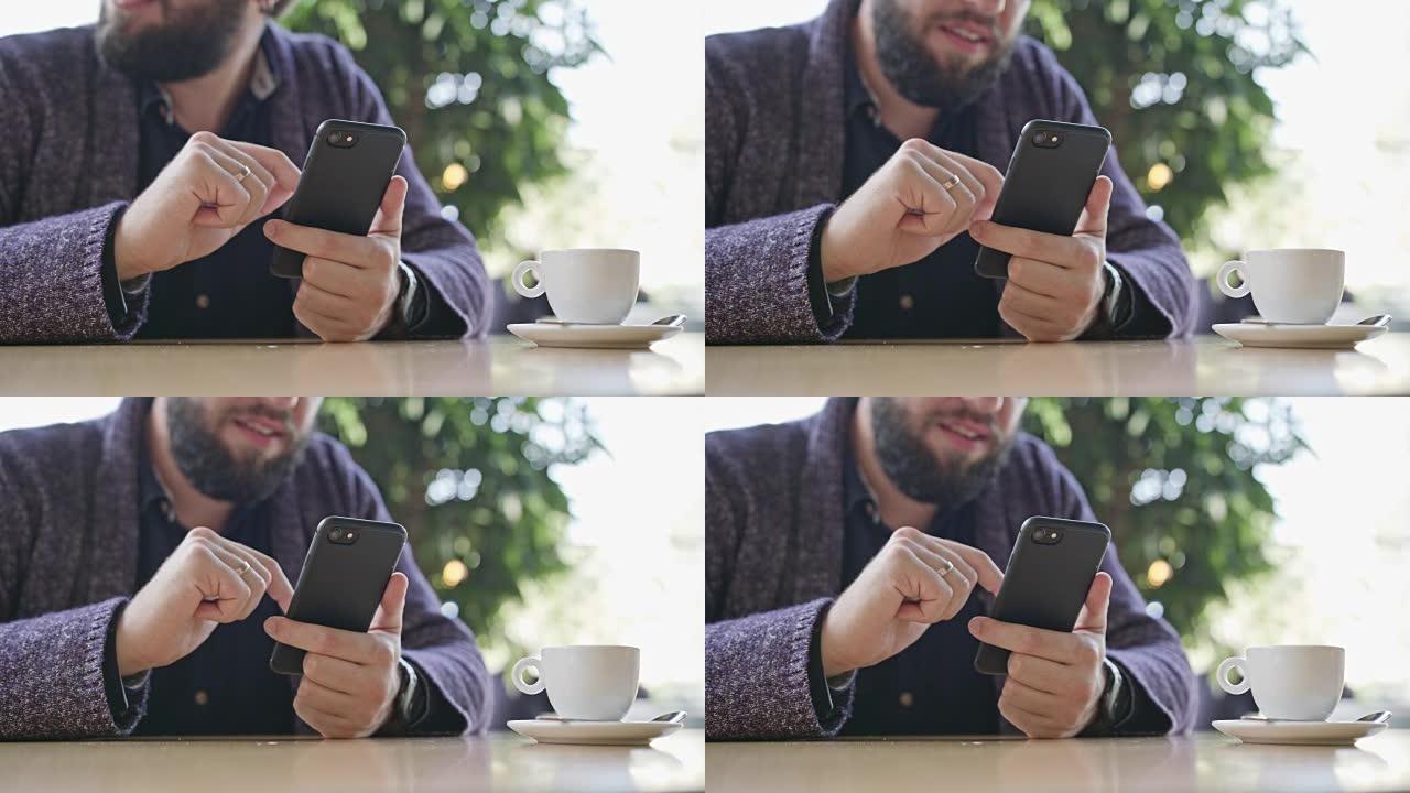 一个年轻人在咖啡馆里使用智能手机