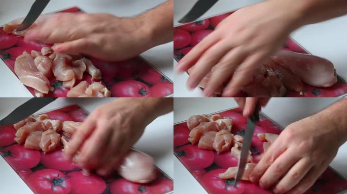 厨师用刀切碎鸡肉。在砧板上。