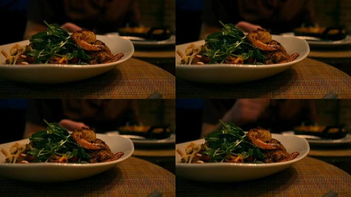坐在桌子上的一家高档餐厅的美味虾和面食