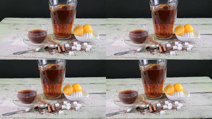 红茶，带柠檬的手动榨汁机。一壶红茶和方糖。