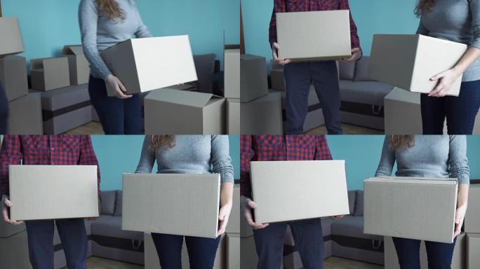 年轻夫妇在盒子里收集东西，以便搬到新公寓