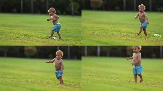 婴儿宝宝起床，在外面的花园草坪上奔跑。3岁男婴在理想的黄金时间日落奔跑的自然瞬间