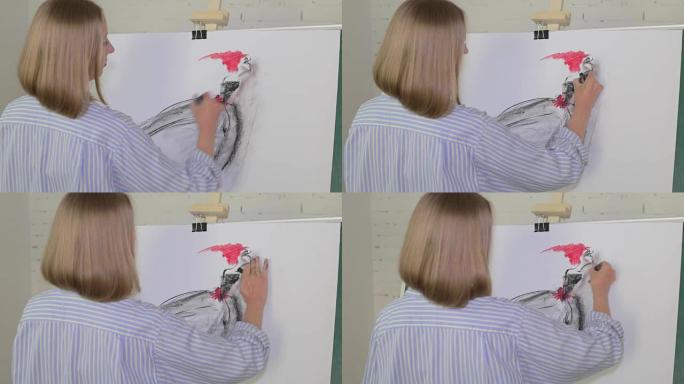 金发女艺术家用煤在画布上画一个女人。画布立在画架上。绘图过程