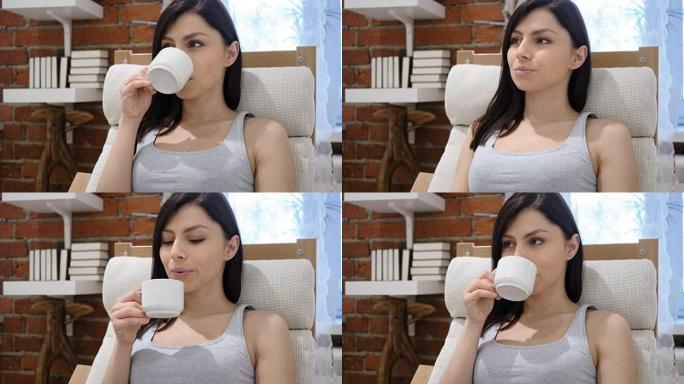 年轻女子喝杯咖啡的肖像