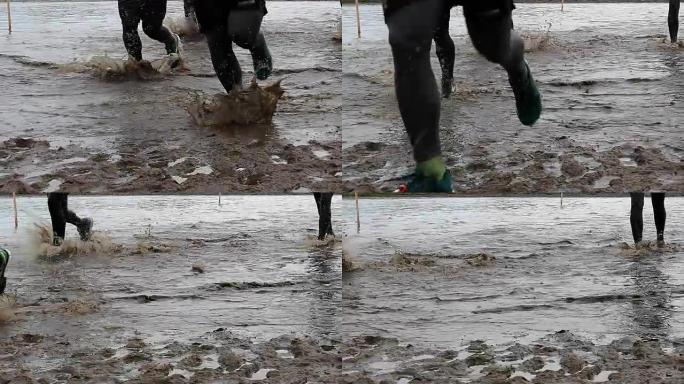 障碍耐力赛慢动作中的水和泥中的跑步者