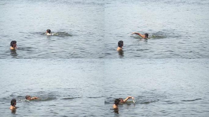 少年在母亲旁边的湖中游泳
