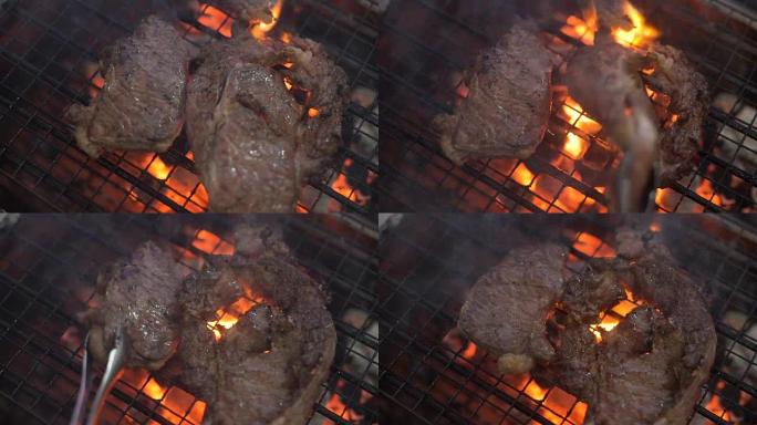 CU: 将牛排放在火烧的烤架上。