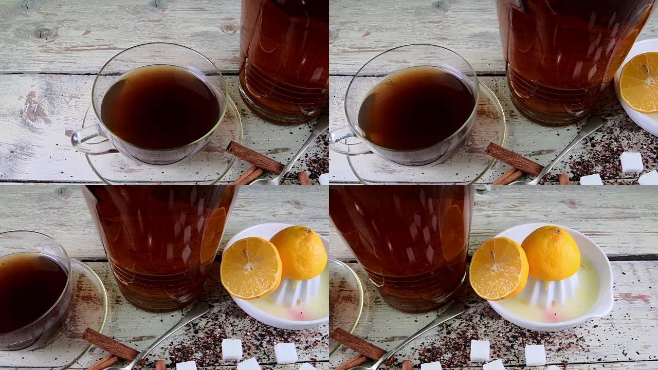 红茶，带柠檬的手动榨汁机。一壶红茶和方糖。