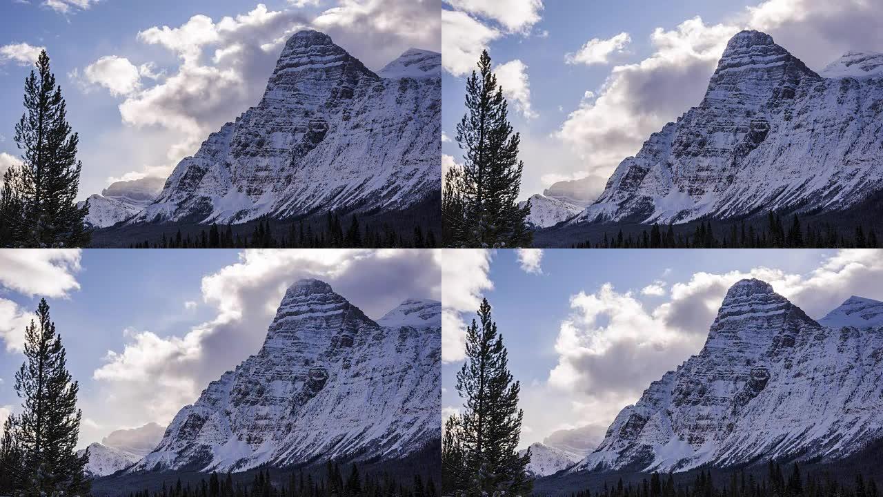Time lapse of clouds above snowy mountain peaks an