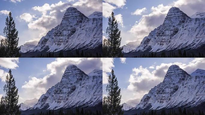 Time lapse of clouds above snowy mountain peaks an