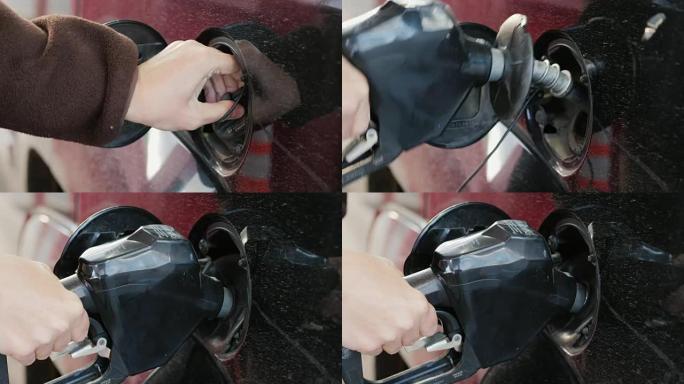 女人打开汽油箱的盖子，给她的车加油。特写