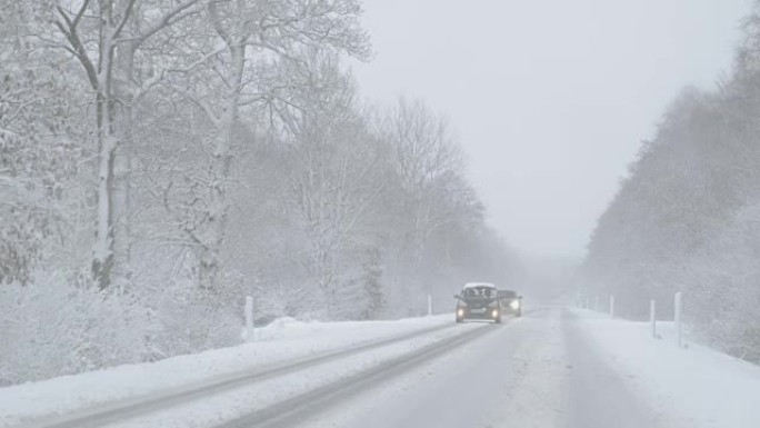 冬季驾驶-雾蒙蒙的一天，大雪中的雪乡道路上迎面而来的交通