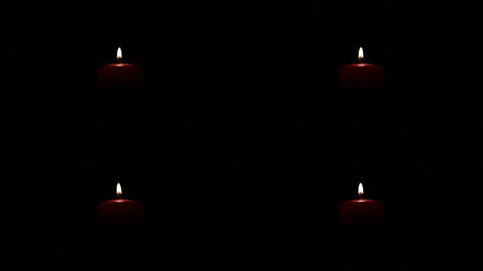 Candle burning on black background