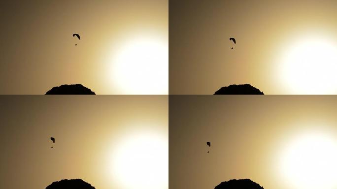 滑翔伞在日落时练习滑翔伞