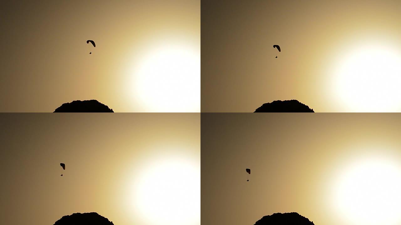 滑翔伞在日落时练习滑翔伞