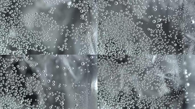 Bubbles on glass with sparkling water in rotation