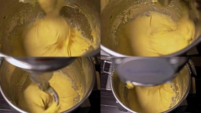 在制造过程中，用专业捏合机螺旋机混合面团用于面包烘焙。面团被揉成汉堡。非常甜美的郁郁葱葱的空气面包。