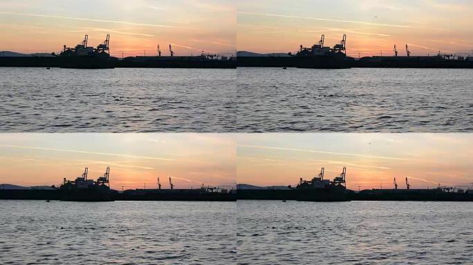 保加利亚工业黑海港口布尔加斯的susnet起重机剪影。