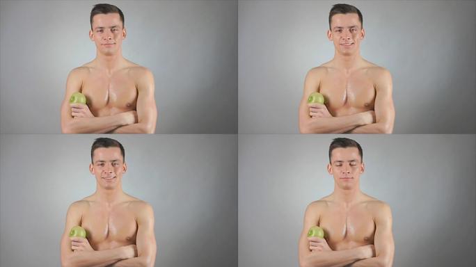 健康的生活方式。性感的家伙和绿苹果。