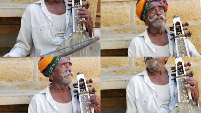 印度男子在印度拉贾斯坦邦Jaisalmer Fort演奏传统乐器