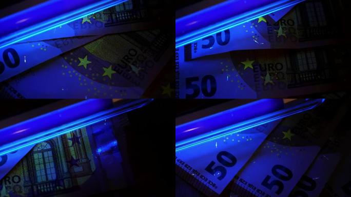 伪钞检测。用紫外线咀嚼欧元纸币。