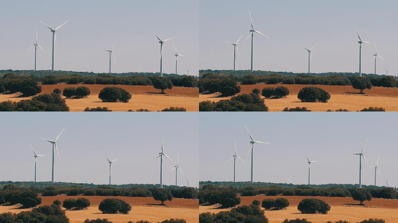 美丽的风车涡轮机在西班牙领域利用清洁，绿色，风能。风车动力技术、绿色技术、清洁可再生能源解决方案