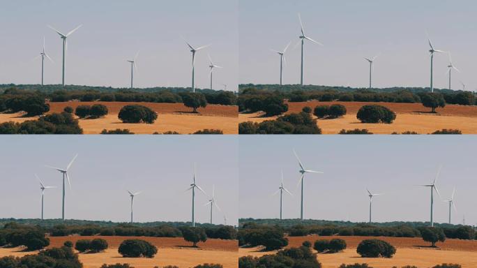 美丽的风车涡轮机在西班牙领域利用清洁，绿色，风能。风车动力技术、绿色技术、清洁可再生能源解决方案