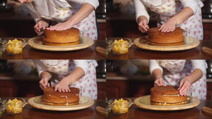 一个女人的手的特写镜头将新鲜出炉的蛋糕切成碎片