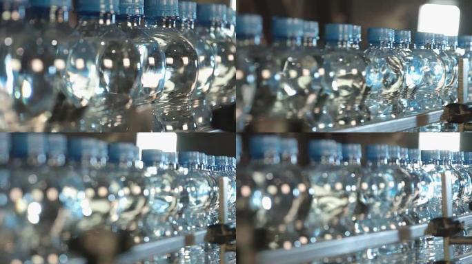 装满的蓝盖水瓶在工厂生产线上缓慢移动