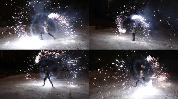 令人惊叹的部落火灾表演在冬天的夜晚在飘雪下跳舞。舞蹈团在下雪的天气用火炬灯和烟火表演