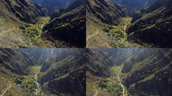 空中无人机拍摄了山脉之间的森林ravibe，河流和下面的废弃修道院