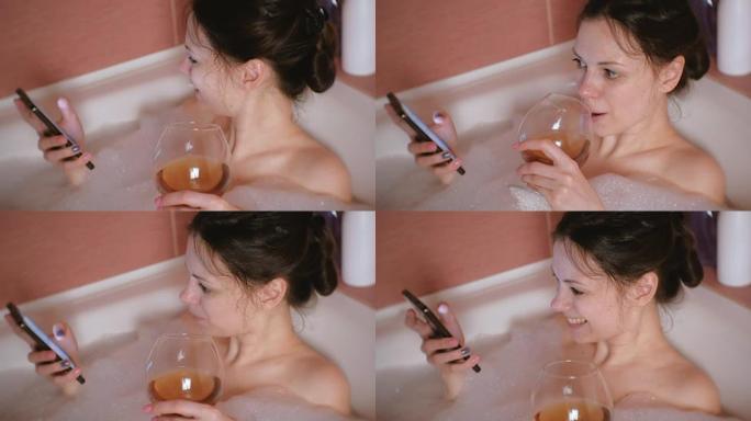 年轻漂亮的女人洗澡，用手机浏览互联网，喝威士忌。