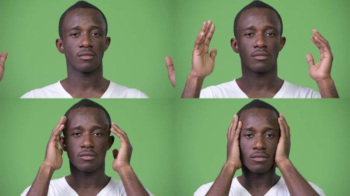 年轻的非洲男子遮住耳朵，成为三只明智的猴子的概念