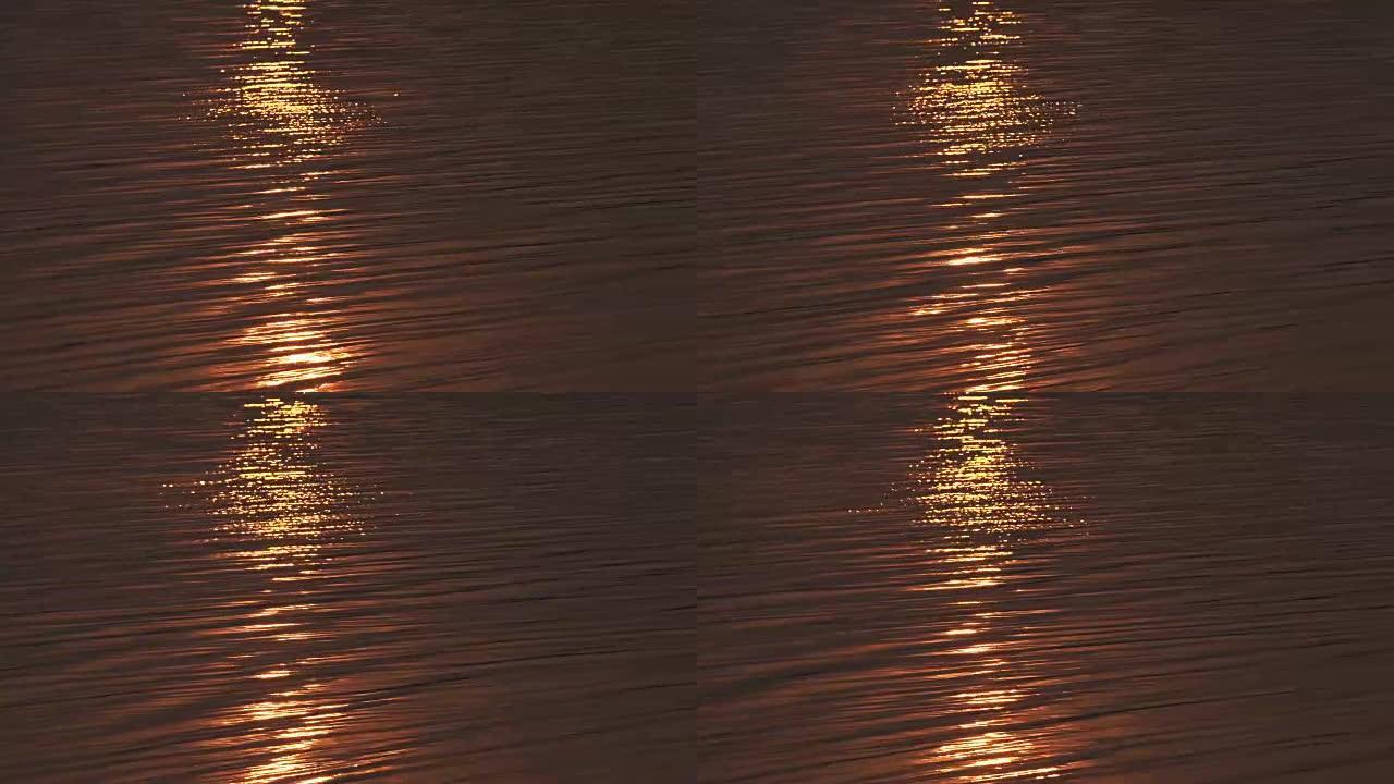 波浪水，日落时金色暖色调。可用于背景。