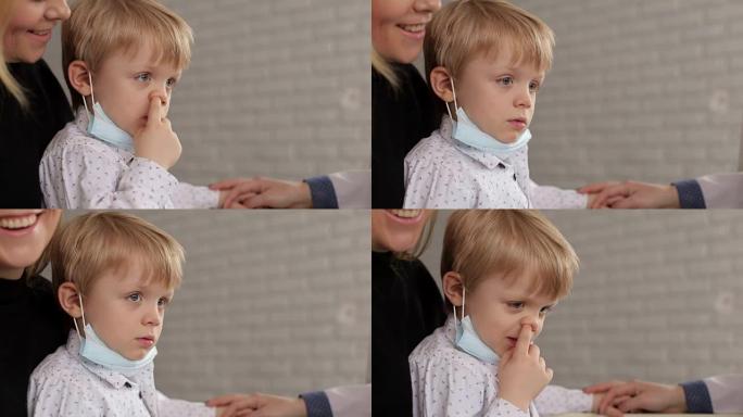 一个小孩用手指指着鼻子，特写镜头