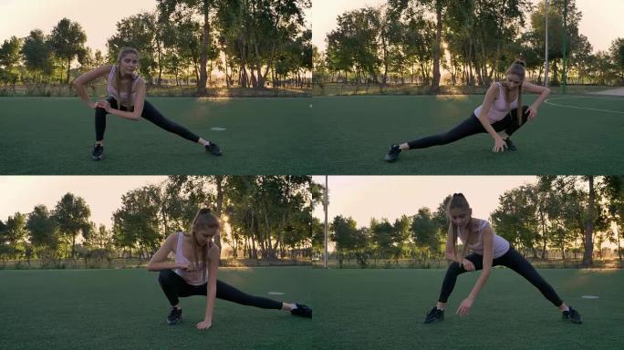 日落时，年轻美丽的女人在公园的足球场上伸展，健身模型锻炼