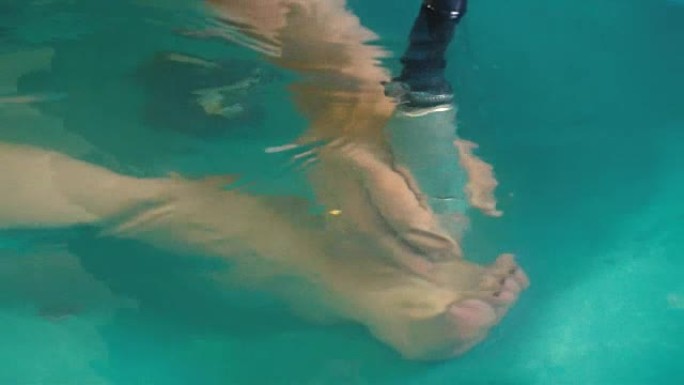 在水力按摩过程中，手部按摩女性的脚