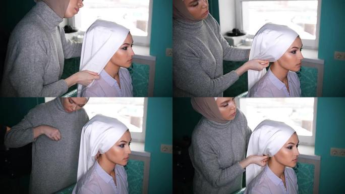 两名穆斯林妇女绑上伊斯兰头巾，准备举行婚礼