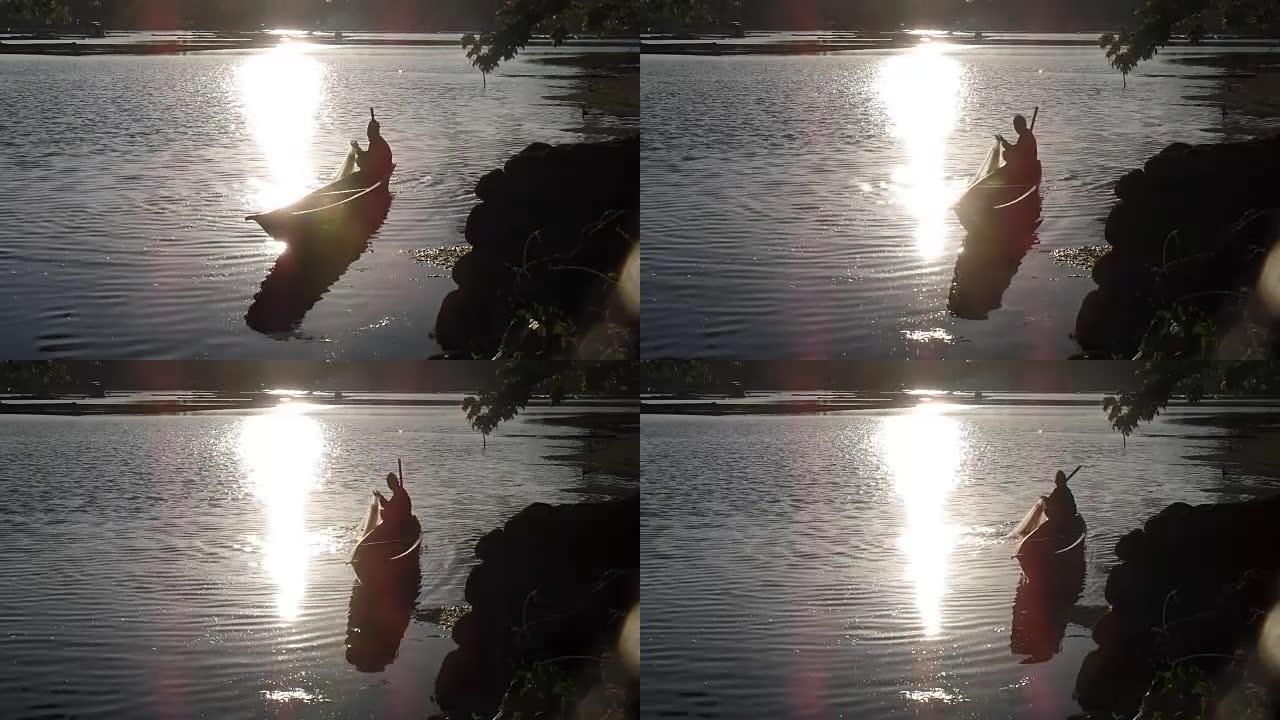 日落时山湖充满活力的金色反射。剪影