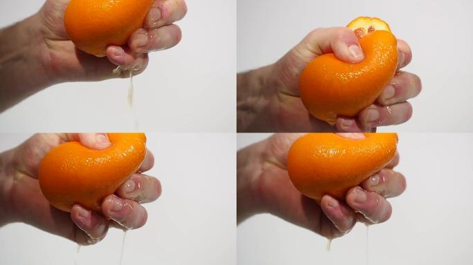 男性用手榨新鲜橙汁。用手榨橙子