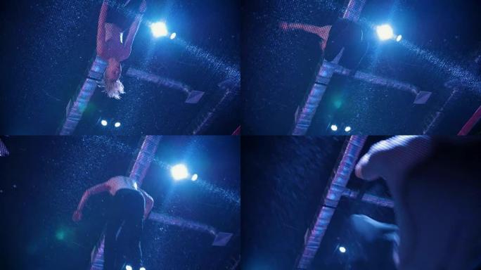 年轻的肌肉男杂技演员在蹦床上跳跃 -- 慢动作，底部视图