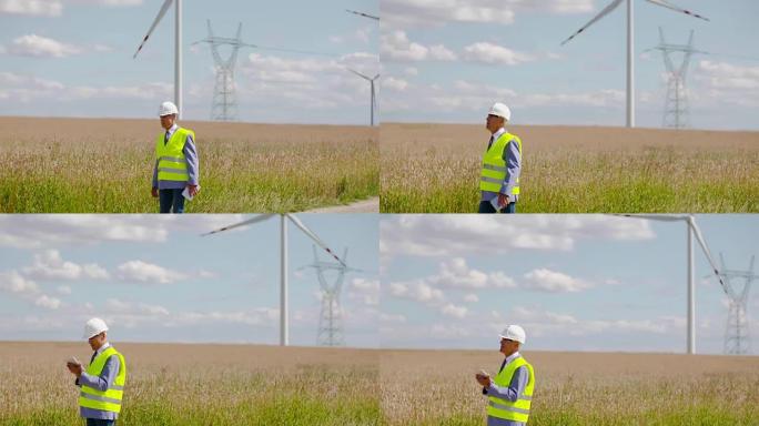 在数字平板电脑上工作的能源工程师再次成为风车农场。