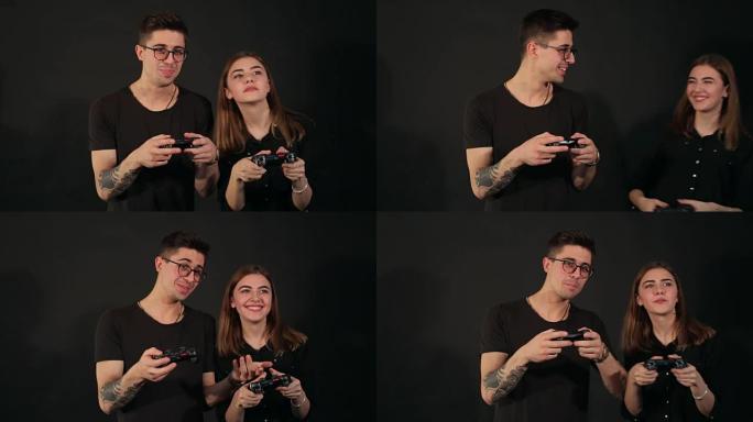 情侣在黑色背景上玩电子游戏。