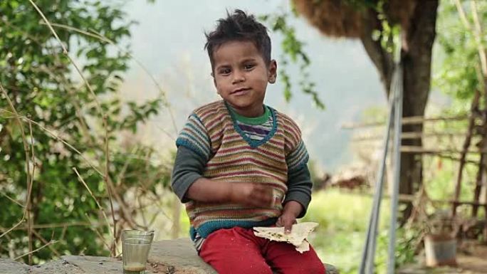 印度农村男孩吃面包和茶的食物。