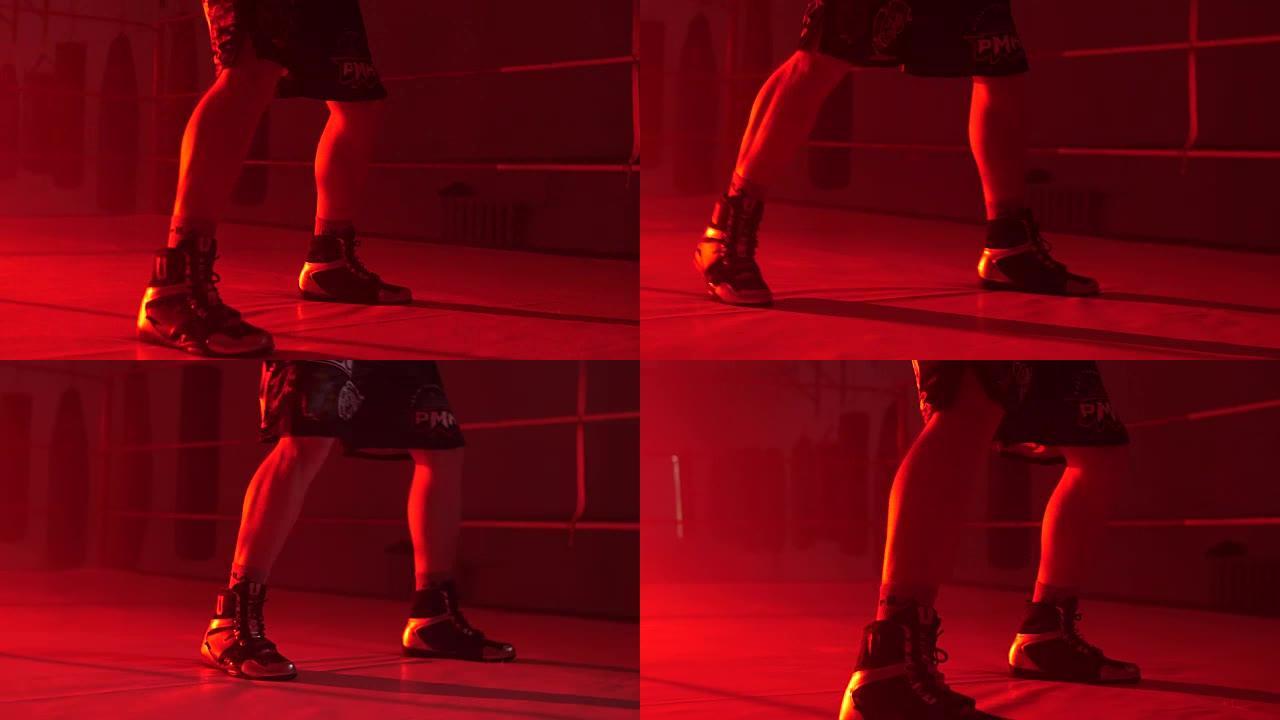 男子运动员在健身房站着做太极拳练习。拳击手进行影子战斗