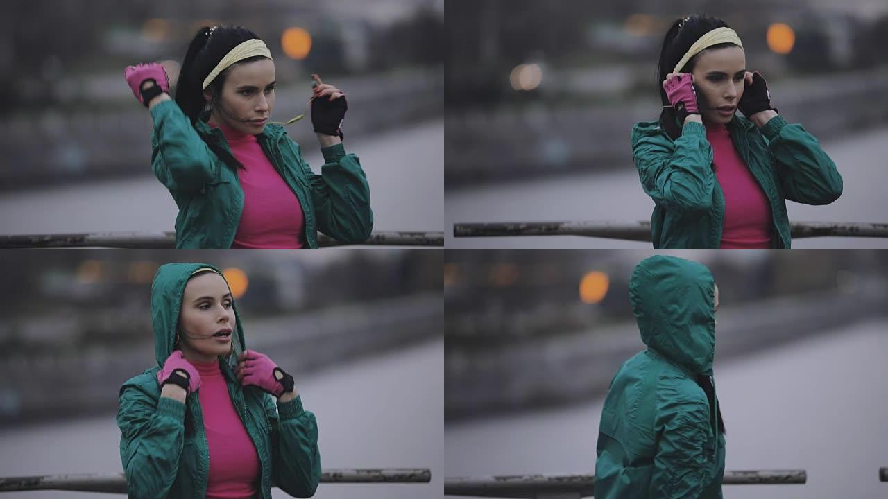 女人慢跑者在寒冷的冬天戴兜帽和无线耳机