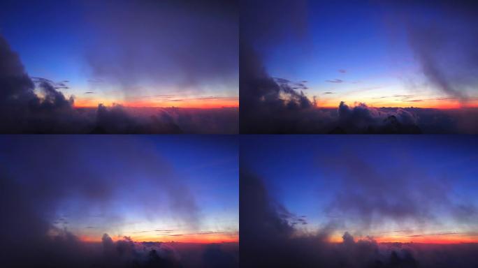 Landscape of rolling clouds over mountain.