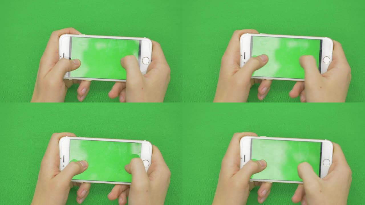 在绿屏上使用智能手机，具有各种手势，水平，特写-绿屏