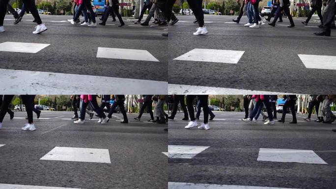 人们在人行横道上过马路。慢动作。