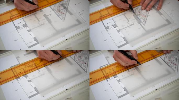 工程师用铅笔和尺子在描图纸上绘制几何形状
